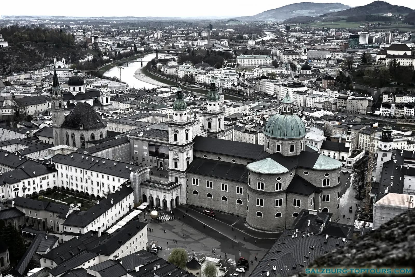 Moody black and white street photography of Salzburg Old Town on Easter Saturday, featuring the Hohensalzburg Fortress through a dramatic filter